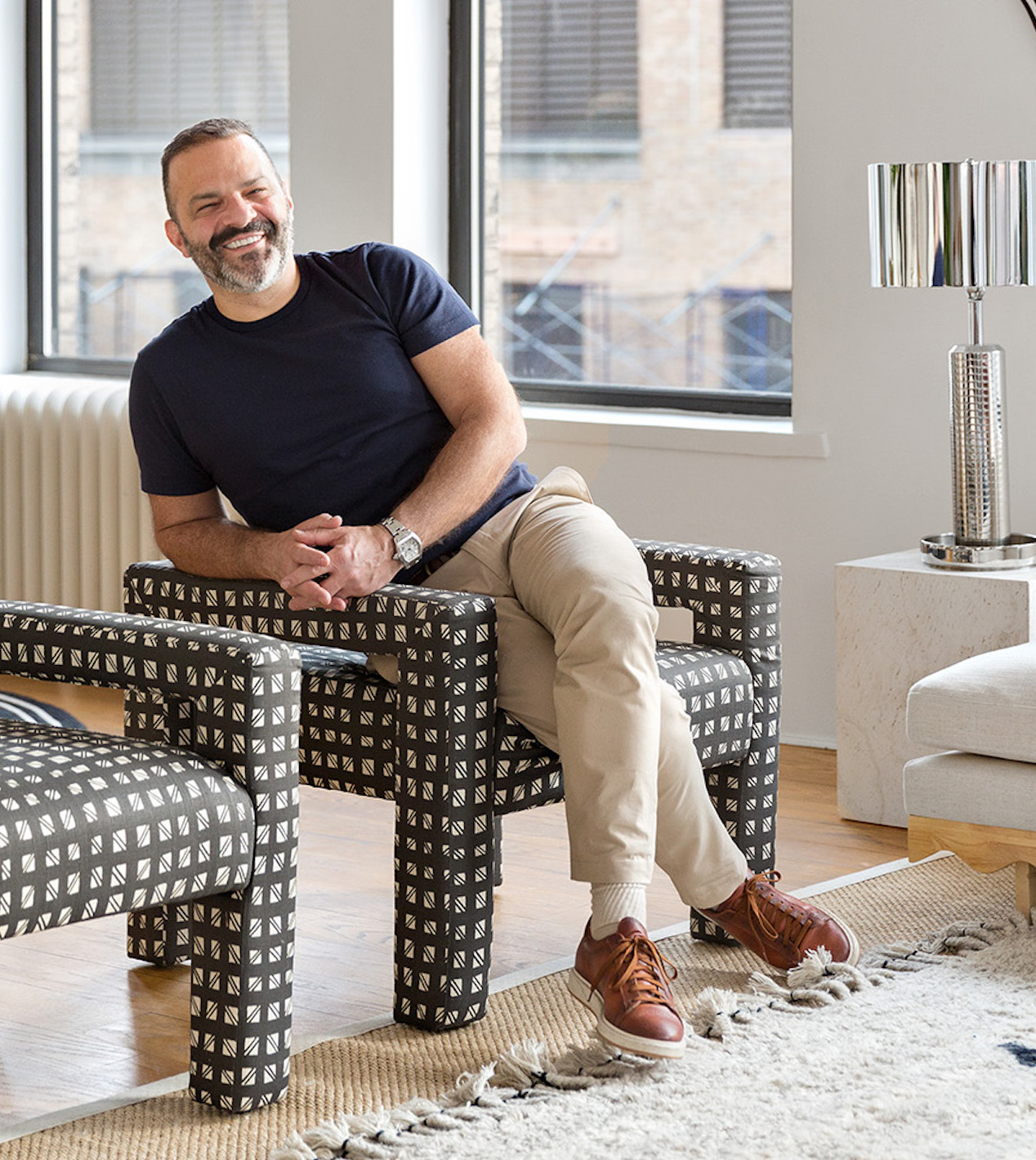 Jason Saft, award winning home stager headshot on black and white modern chair