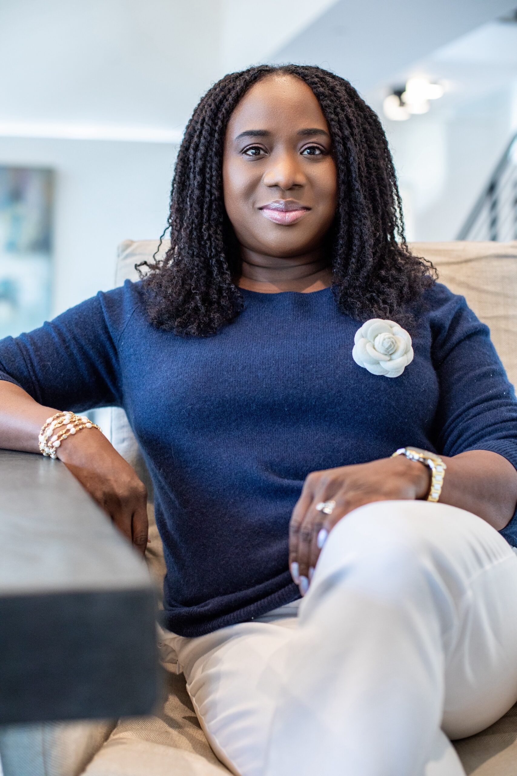 Joké Durojaiye sitting in a stylish home setting, ready to share her insights on automating a home staging business at RESACON.